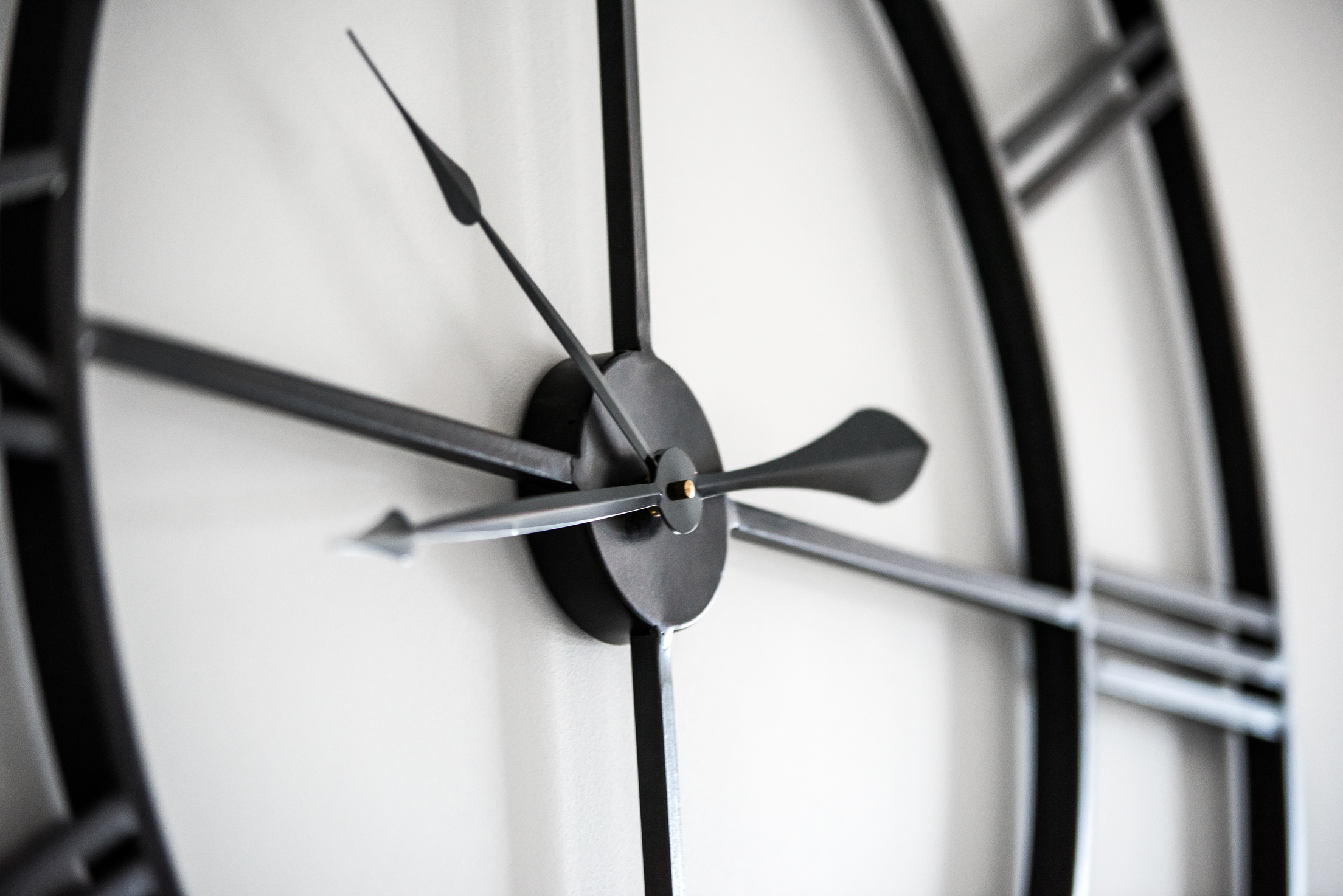 Modern clock on white wall