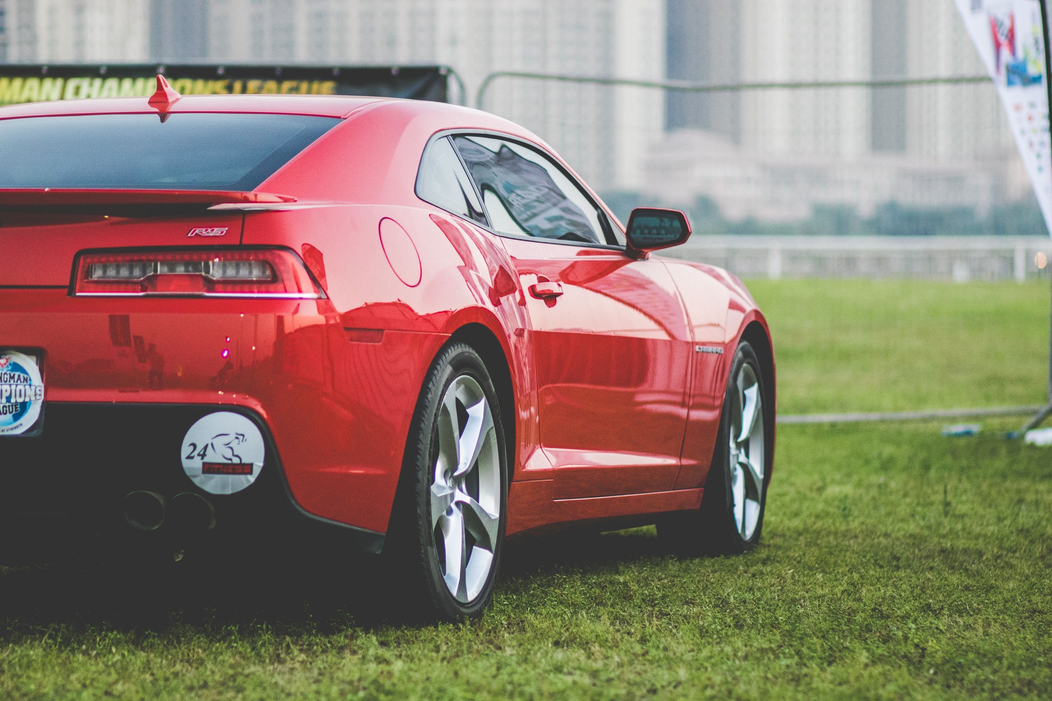 Red Coupe Parked on Green Grasses